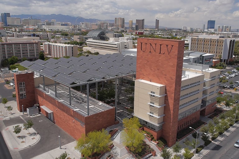 An aerial view of campus with the Strip in the background and Greenspun Hall in the foreground.