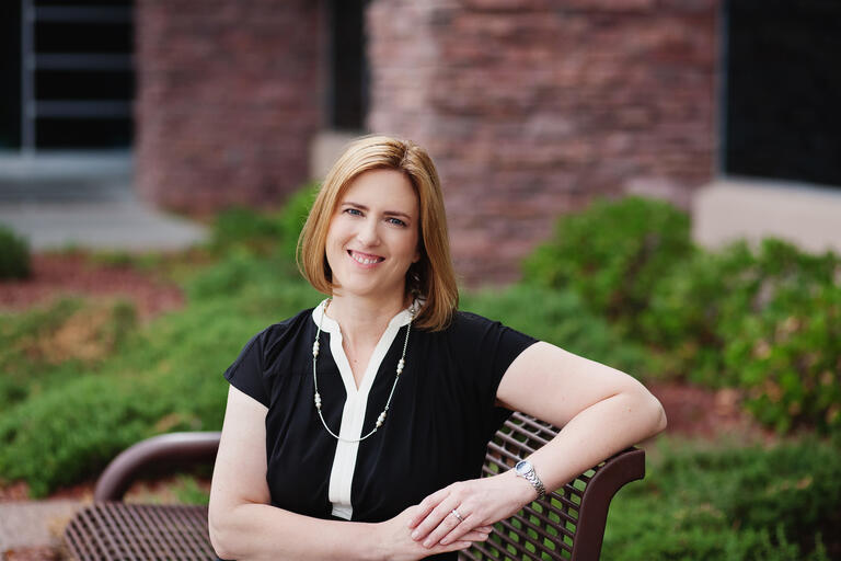 Becky Harris seated on exterior bench